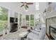 Bright living room with a fireplace, skylights, hardwood floors, and comfortable seating arrangements at 10510 Inverness Ct, Fishers, IN 46037