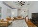 Open living area boasting a large sectional sofa, hardwood floors, and a ceiling fan at 10510 Inverness Ct, Fishers, IN 46037