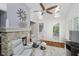 Bright sunroom with a fireplace, tile floors, skylights and a sliding door leading to an outdoor patio at 10510 Inverness Ct, Fishers, IN 46037