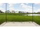 Backyard view showcasing the green lawn, a pond, and the houses in the neighborhood at 11588 Brooks Farm Blvd, Noblesville, IN 46060