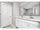 Double vanity bathroom featuring white cabinets, quartz countertops, and a large mirror at 11588 Brooks Farm Blvd, Noblesville, IN 46060