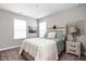 Cozy bedroom featuring natural light, comfortable bed with neutral bedding, and stylish decor at 11588 Brooks Farm Blvd, Noblesville, IN 46060