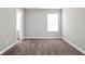 Neutral bedroom featuring plush carpeting, light gray walls, and a single window at 11588 Brooks Farm Blvd, Noblesville, IN 46060