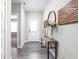 Welcoming entryway features a stylish console table, decor, and elegant wood-look flooring at 11588 Brooks Farm Blvd, Noblesville, IN 46060