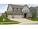 Charming two-story home with a well-maintained lawn, inviting curb appeal, and an attached two car garage at 11588 Brooks Farm Blvd, Noblesville, IN 46060