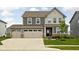 Charming two-story home with a well-maintained lawn, inviting curb appeal, and an attached two car garage at 11588 Brooks Farm Blvd, Noblesville, IN 46060