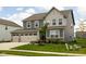 Charming two-story home with a well-maintained lawn, inviting curb appeal, and an attached two car garage at 11588 Brooks Farm Blvd, Noblesville, IN 46060