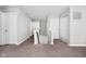 Upstairs hallway features plush neutral carpeting, white doors and trim, and a staircase at 11588 Brooks Farm Blvd, Noblesville, IN 46060
