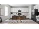 Kitchen features a granite countertop island, white cabinets, modern appliances and dining area at 11588 Brooks Farm Blvd, Noblesville, IN 46060