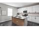 Kitchen features a granite countertop island, white cabinets and modern appliances at 11588 Brooks Farm Blvd, Noblesville, IN 46060