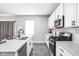 Well-lit kitchen with stainless steel appliances, bright countertops, and wood-look flooring at 11588 Brooks Farm Blvd, Noblesville, IN 46060