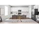 Open kitchen with white cabinets, stainless steel appliances, and an island with seating at 11588 Brooks Farm Blvd, Noblesville, IN 46060