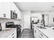 Modern kitchen with stainless steel appliances, white cabinets and countertops, and wood-look flooring at 11588 Brooks Farm Blvd, Noblesville, IN 46060