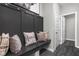 Mudroom area features built-in storage bench, hooks, modern decor, and hardwood flooring at 11588 Brooks Farm Blvd, Noblesville, IN 46060