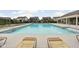 Community pool with lounge chairs and clear blue water, surrounded by well-maintained landscaping at 11588 Brooks Farm Blvd, Noblesville, IN 46060
