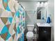 Well-lit bathroom with a modern vanity, toilet, and stylish shower curtain at 117 N Market St, Thorntown, IN 46071
