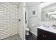 Bathroom featuring walk-in shower with white subway tile and a stylish vanity at 117 N Market St, Thorntown, IN 46071