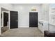 An open doorway leads to a light-filled bedroom with wood-look floors, closet, and a changing table at 117 N Market St, Thorntown, IN 46071