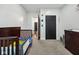 A cozy bedroom has a crib, a changing table, closet space, and an open view to other parts of the home at 117 N Market St, Thorntown, IN 46071