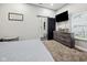 Bright bedroom with a TV, dresser, and sliding barn door to an en-suite bathroom at 117 N Market St, Thorntown, IN 46071