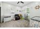 A bedroom is carpeted and filled with natural light, with toys, a baby's crib, and lots of space at 117 N Market St, Thorntown, IN 46071