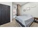Comfortable bedroom with a brick accent wall, modern decor, and plush carpeting at 117 N Market St, Thorntown, IN 46071