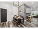 A dining room with a wood table, bench, chair seating, decorative items on the wall, and wood-style flooring at 117 N Market St, Thorntown, IN 46071