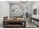 The dining room features a wood table with a bench and chairs, with views into other rooms in the house at 117 N Market St, Thorntown, IN 46071
