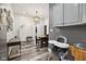 An open-concept dining room features stylish floors, a modern light fixture, and a view to the other living spaces at 117 N Market St, Thorntown, IN 46071