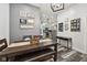 The dining room features a wood table with bench and chair seating, and a view into the kitchen at 117 N Market St, Thorntown, IN 46071