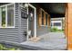 Inviting covered porch with stylish details, offering a cozy outdoor space to welcome guests and enjoy the neighborhood at 117 N Market St, Thorntown, IN 46071
