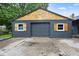 Detached garage with new wood siding and a concrete driveway at 117 N Market St, Thorntown, IN 46071