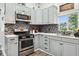 Modern kitchen with stainless steel appliances, decorative backsplash, and ample counter space for an efficient cooking area at 117 N Market St, Thorntown, IN 46071