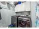 Efficient laundry room with modern washer and dryer, overhead shelving, and bright lighting at 117 N Market St, Thorntown, IN 46071