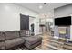 Modern living room with sleek flooring, a sliding barn door, and an open layout leading to the kitchen for easy living at 117 N Market St, Thorntown, IN 46071