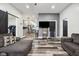 Open-concept living area with stylish floors, a gray accent wall, and seamless access to the kitchen, ideal for entertaining at 117 N Market St, Thorntown, IN 46071