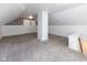 Spacious attic room with carpeting, wallpaper accent wall, and plenty of natural light at 1311 N Oakland Ave, Indianapolis, IN 46201