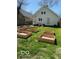 Spacious backyard featuring a well-maintained lawn and multiple raised garden beds at 1311 N Oakland Ave, Indianapolis, IN 46201