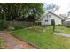 Inviting backyard with a lush garden, wooden fence, and well-maintained lawn at 1311 N Oakland Ave, Indianapolis, IN 46201