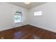 Cozy bedroom with hardwood floors and natural light from the windows and a large window at 1311 N Oakland Ave, Indianapolis, IN 46201