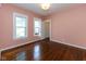 Bedroom featuring hardwood floors and natural light from the windows at 1311 N Oakland Ave, Indianapolis, IN 46201