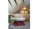 Charming bedroom featuring a comfortable bed, stylish wallpaper, and cozy red area rug at 1311 N Oakland Ave, Indianapolis, IN 46201