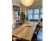 Dining room featuring a large wooden table, modern seating, and bright windows at 1311 N Oakland Ave, Indianapolis, IN 46201
