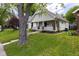 Charming two-story home featuring a welcoming front porch and well-maintained lawn at 1311 N Oakland Ave, Indianapolis, IN 46201