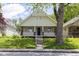 Charming home with a welcoming front porch and mature trees, perfect for relaxing outdoors at 1311 N Oakland Ave, Indianapolis, IN 46201
