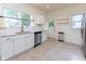 Bright kitchen features stainless steel appliances, white cabinets, and updated fixtures at 1311 N Oakland Ave, Indianapolis, IN 46201