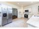 Modern kitchen features stainless steel appliances, white cabinets, and herringbone tile flooring at 1311 N Oakland Ave, Indianapolis, IN 46201