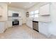Updated kitchen with stainless appliances, white cabinets, and stylish tile flooring and backsplash at 1311 N Oakland Ave, Indianapolis, IN 46201