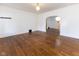 Bright living room with gleaming hardwood floors and archway into the dining area at 1311 N Oakland Ave, Indianapolis, IN 46201