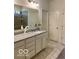 Bathroom features a granite countertop, cabinets, large mirror and a glass-enclosed shower at 1349 Sunset Blvd, Avon, IN 46123